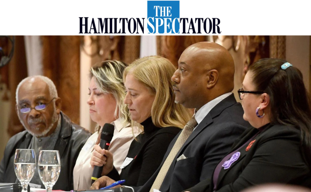 Five individuals sitting at a table on a panel of speakers at a community safety summit in Hamilton, Ontario on November 10, 2025