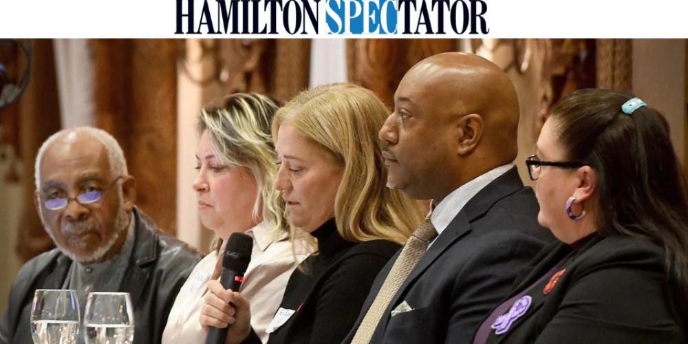Five individuals sitting at a table on a panel of speakers at a community safety summit in Hamilton, Ontario on November 10, 2025